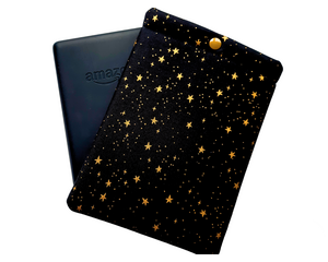 A pouch with a snap closure to protect Kindle e-readers made with black with gold metallic stars fabric.